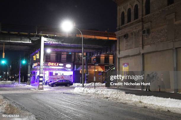 Astreet Artist writes graffiti on a building in Brooklyn after a massive winter storm on January 4, 2018 in New York, United States. New York City...