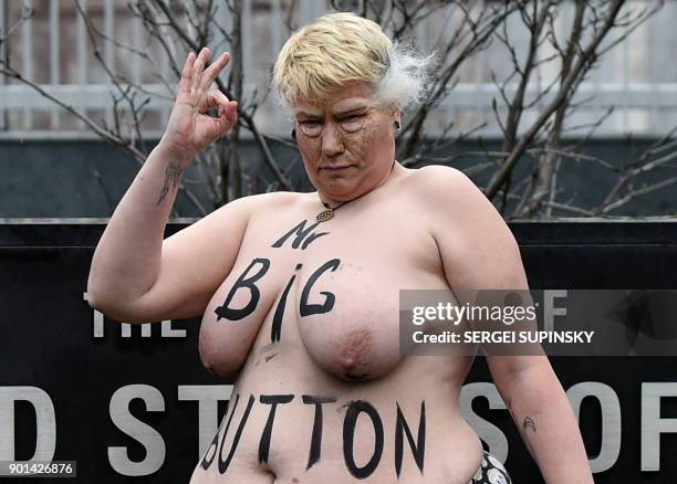 Topless activist of the Ukrainian women's movement Femen maked up as US President Donald Trump and with an inscription on her body reading "Mr. Big...