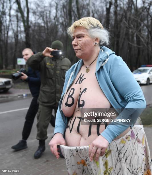 Topless activist of the Ukrainian women's movement Femen maked up as US President Donald Trump and with an inscription on her body reading "Mr. Big...