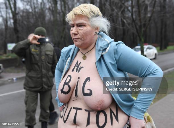 Topless activist of the Ukrainian women's movement Femen maked up as US President Donald Trump and with an inscription on her body reading "Mr. Big...