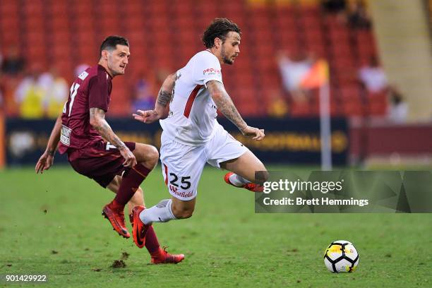 Christopher Herd of the Wanderers is tackled by Corey Gameiro of Brisbane during the round 14 A-League match between the Brisbane Roar and the...