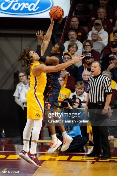 Reggie Lynch of the Minnesota Golden Gophers blocks a shot by Leron Black of the Illinois Fighting Illini during the game on January 3, 2018 at...