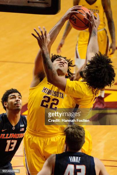 Reggie Lynch of the Minnesota Golden Gophers grabs a rebound against teammate Jordan Murphy during the game against the Illinois Fighting Illini on...