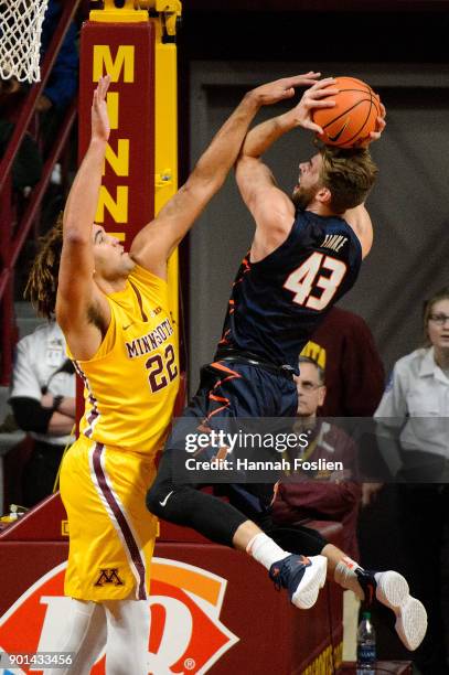 Reggie Lynch of the Minnesota Golden Gophers blocks a shot by Michael Finke of the Illinois Fighting Illini during the game on January 3, 2018 at...