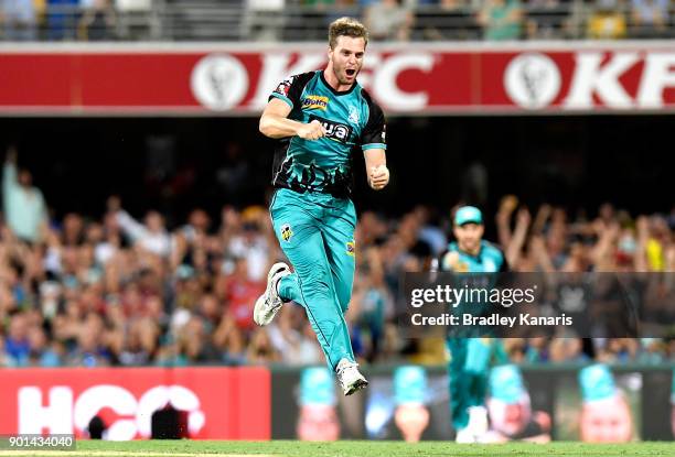 Mark Steketee of the Heat celebrates taking the wicket of Hilton Cartwright of the Scorchers during the Big Bash League match between the Brisbane...