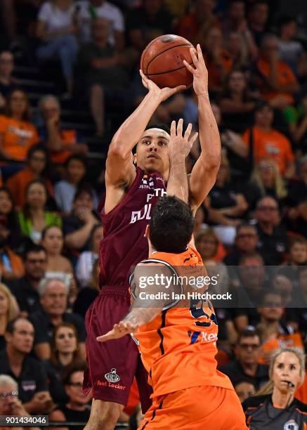 Travis Trice of the Bullets takes a jump shot over Jarrad Weeks of the Taipans during the round 13 NBL match between the Cairns Taipans and the...