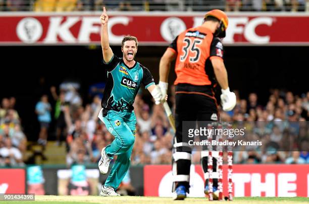 Mark Steketee of the Heat celebrates taking the wicket of Hilton Cartwright of the Scorchers during the Big Bash League match between the Brisbane...