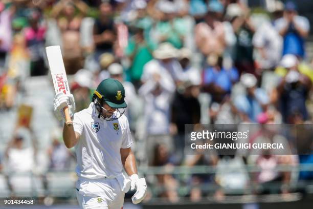 South African batsman AB de Villiers raises his bat as he celebrates scoring a Half-Century during day one of the First Test between South Africa and...