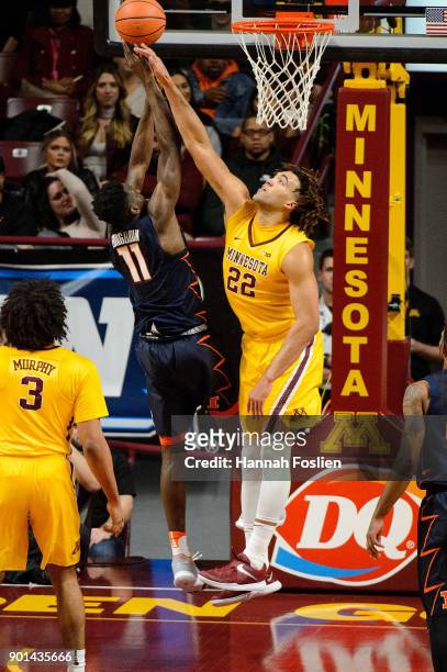 Reggie Lynch of the Minnesota Golden Gophers blocks a shot by Greg Eboigbodin of the Illinois Fighting Illini during the game on January 3, 2018 at...