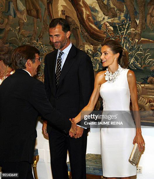 Spain's Prince Felipe and Princess Letizia greet people during a summer dinner of farewell at Almudaina Palace in Palma de Mallorca, on August 28,...