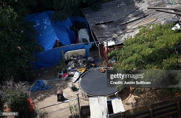 Tarps, tents and a wooden structure are seen in the backyard of alleged kidnapper Phillip Garrido August 28, 2009 in Antioch, California. Jaycee Lee...