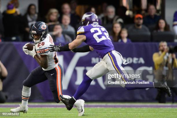Tarik Cohen of the Chicago Bears carries the ball against Harrison Smith of the Minnesota Vikings during the game on December 31, 2017 at U.S. Bank...