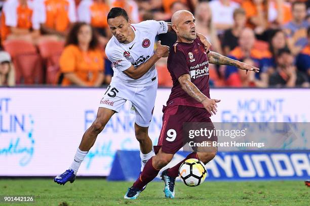 Massimo Maccarone of Brisbane is tackled by Kearyn Baccus of the Wanderers during the round 14 A-League match between the Brisbane Roar and the...