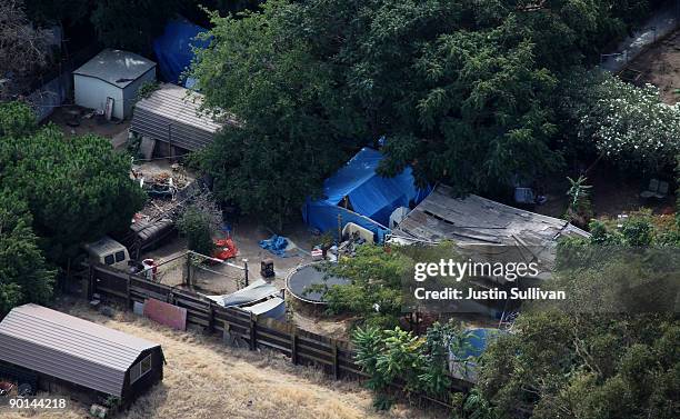 Tarps, tents and a wooden structure are seen in the backyard of alleged kidnapper Phillip Garrido August 28, 2009 in Antioch, California. Jaycee Lee...