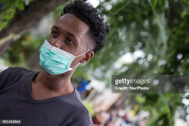 Waiting to enter the Immigration complex outside of Indonesia immigration detention place. Dozens of refugee from Afghanistan, Sudan, and Somalia...