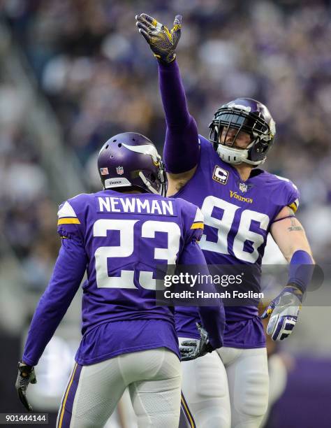 Terence Newman and Brian Robison of the Minnesota Vikings celebrate a sack against the Chicago Bears during the game on December 31, 2017 at U.S....