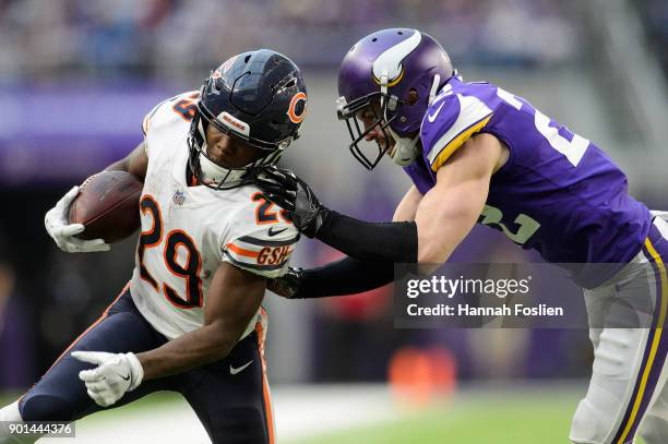 Tarik Cohen of the Chicago Bears carries the ball against Harrison Smith of the Minnesota Vikings during the game on December 31, 2017 at U.S. Bank...