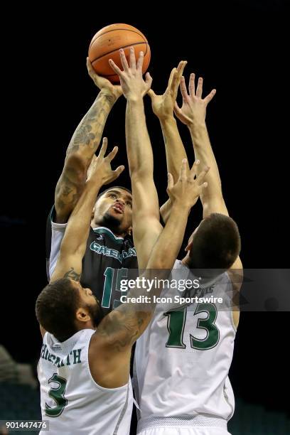 Green Bay Phoenix forward Manny Patterson goes up for a shot as Cleveland State Vikings Dontel Highsmith and Cleveland State Vikings Stefan Kenic...