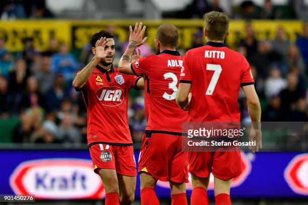 Nikola Mileusnic congratulates Daniel Adlung of Adelaide after he scores a goal during the round 14 A-League match between the Perth Glory and...