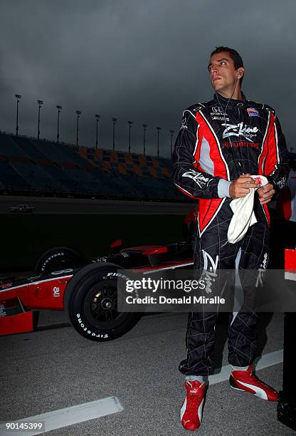 Justin Wilson, driver of the Z-Line Designs Dale Coyne Racing Dallara Honda, looks on from his car during qualifying for the IRL IndyCar Series PEAK...