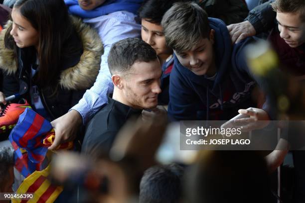 Barcelona's Belgian defender Thomas Vermaelen poses for a selfie with young supporters during a training session in Barcelona on January 5, 2018. /...