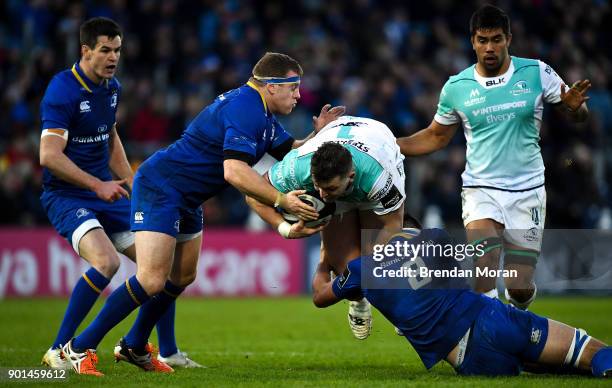 Dublin , Ireland - 1 January 2018; Denis Coulson of Connacht is tackled by Sean Cronin and Max Deegan of Leinster during the Guinness PRO14 Round 12...