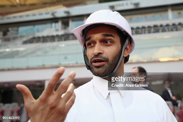 Hassan Al Thawadi, the Secretary General of the Qatar's Supreme Committee for Delivery and Legacy presents a solar powerer helmet for the stadium...