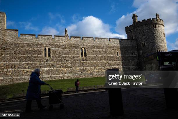 Woman pushes a trolley in front of Windsor Castle on January 5, 2018 in Windsor, England. British Prime Minister Theresa May has publicly challenged...