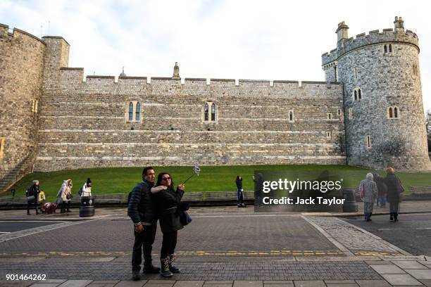 Couple take a photograph with a 'selfie-stick' outside Windsor Castle on January 5, 2018 in Windsor, England. British Prime Minister Theresa May has...