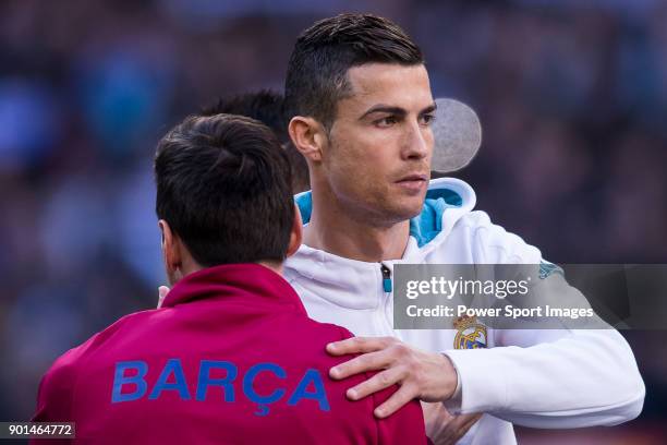 Cristiano Ronaldo of Real Madrid and Lionel Andres Messi of FC Barcelona hug each other prior to the La Liga 2017-18 match between Real Madrid and FC...