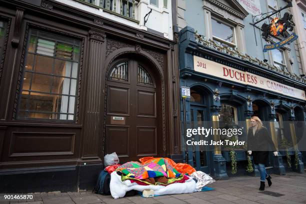 Person sleeps rough in a doorway opposite Windsor Castle on January 5, 2018 in Windsor, England. British Prime Minister Theresa May has publicly...