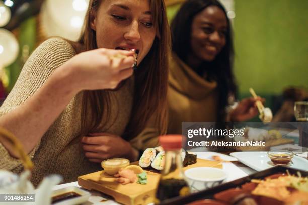 girls having dinner together - sushi bar stock pictures, royalty-free photos & images