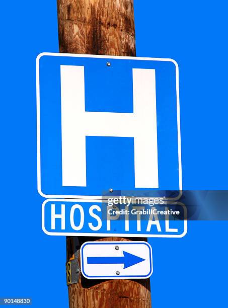 arrow pointing to the hospital blue sky - hospital sign stock pictures, royalty-free photos & images