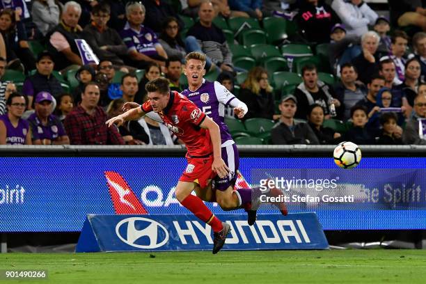 Ryan Strain of Adelaide and Joseph Knowles of the Glory compete for the ball during the round 14 A-League match between the Perth Glory and Adelaide...