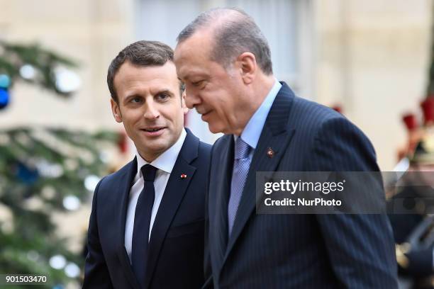 French President Emmanuel Macron welcomes his Turkish counterpart Recep Tayyip Erdogan upon his arrival for their meeting and luncheon on January 5,...