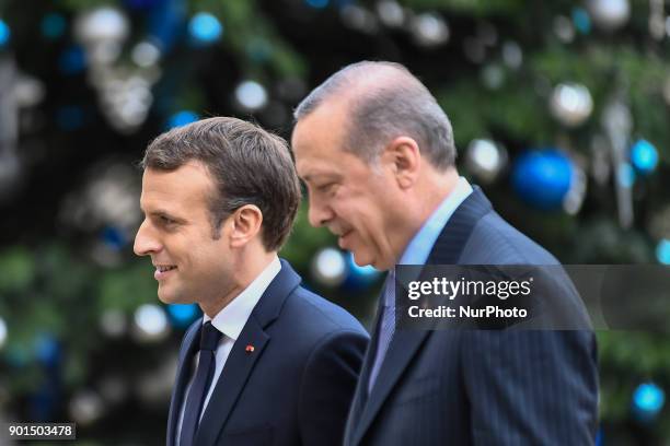 French President Emmanuel Macron welcomes his Turkish counterpart Recep Tayyip Erdogan upon his arrival for their meeting and luncheon on January 5,...