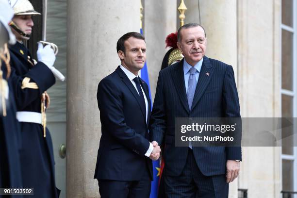 French President Emmanuel Macron welcomes his Turkish counterpart Recep Tayyip Erdogan upon his arrival for their meeting and luncheon on January 5,...