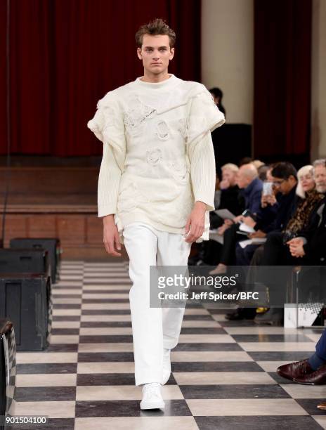 Model walks the runway wearing a design by Ming Lai Lee at the LCFMA18 Menswear show during London Fashion Week Men's January 2018 at St John's,...
