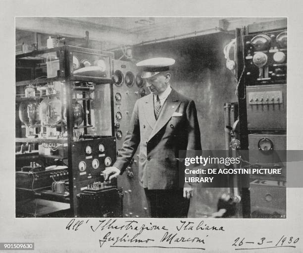 Inventor Guglielmo Marconi in the radio room of the laboratory-yacht Elettra, moored in Genoa, Italy, sends electricity via radio in order to...