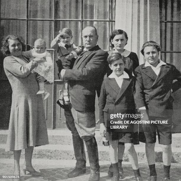 The Mussolini family, from left to right: Rachele Guidi with daughter Anna Maria in her arms, Benito Mussolini with son Romano in his arms, Edda,...