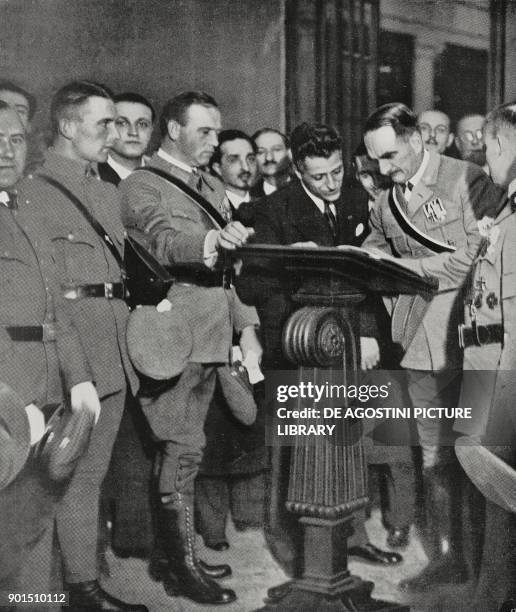 Doctor Heckner, representative of the Stahlhelm , signs the visitors book of the martyrs crypt in the Casa del Fascio in Milan, Italy, from...