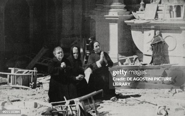 Women praying in the ruins of a church hit by allied bombing, Cagliari, Italy, World War II, from L'Illustrazione Italiana, Year LXX, No 24, June 13,...