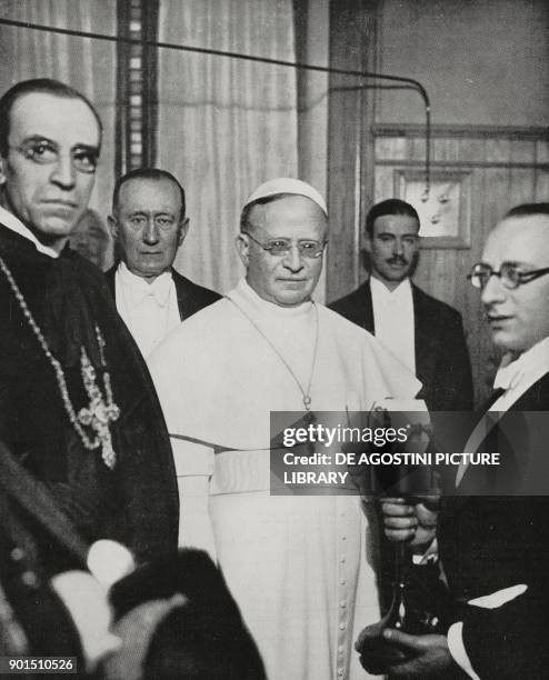 Pope Pius XI , center, on the inauguration of the Vatican radio station, behind, left, inventor Guglielmo Marconi , February 12 Vatican City, photo...