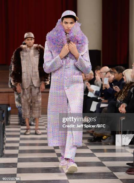 Model walks the runway wearing a design by Xu Bo at the LCFMA18 Menswear show during London Fashion Week Men's January 2018 at St John's, Smith...