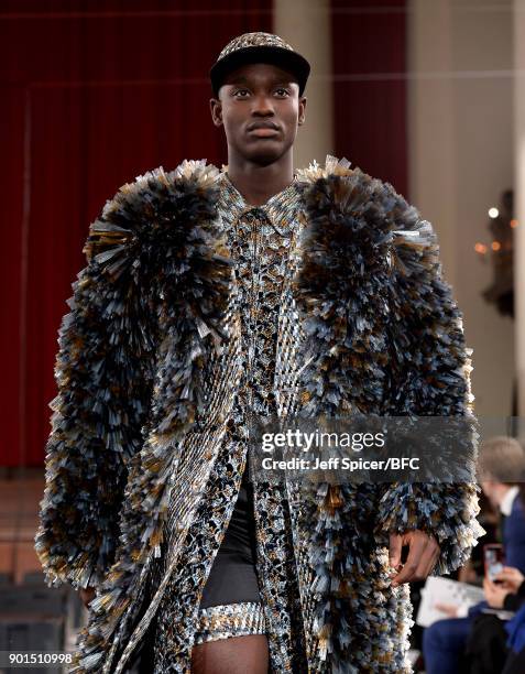 Model walks the runway wearing a design by Xu Bo at the LCFMA18 Menswear show during London Fashion Week Men's January 2018 at St John's, Smith...