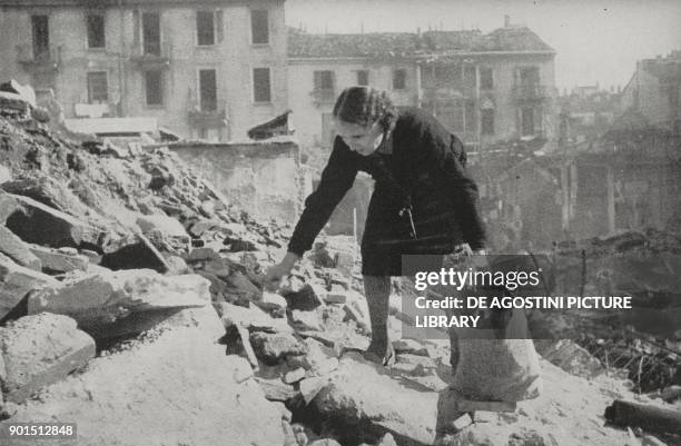 Woman picking through the rubble of a bombed city, Italy, World War II, from L'Illustrazione Italiana, Year LXX, No 43, October 24, 1943.