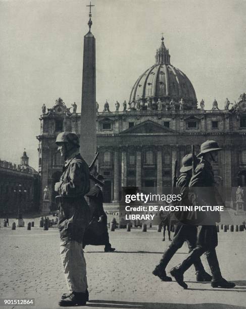 German soldier and two Italian colonial guards in St Peter's Square, on the border between Rome and the Vatican, World War II, from L'Illustrazione...