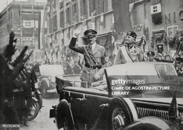 Benito Mussolini and Adolf Hitler, travelling to the Quirinale by car through cheering crowds on Corso Vittorio Emanuele, Rome, Italy, from...