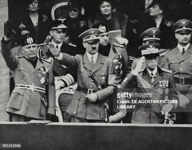 Benito Mussolini, Adolf Hitler and Vittorio Emanuele III saluting the parade of the Italian military units, Rome, Italy, from L'Illustrazione...