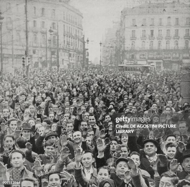 The crowd cheering Francoist troops, Puerta del Sol, Madrid, Spain, Spanish Civil war, from L'Illustrazione Italiana, Year LXVI, No 15, April 9, 1939.